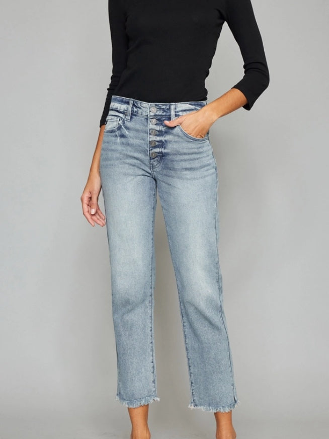 The Morgan High Rise Straight Leg Jeans has the most trendy style with its frayed hem complete with fading and 3D whiskering. This ankle jean sits just above the waist with an overall relaxed straight straight fit.  28" inseam. Light wash with button up fly.
