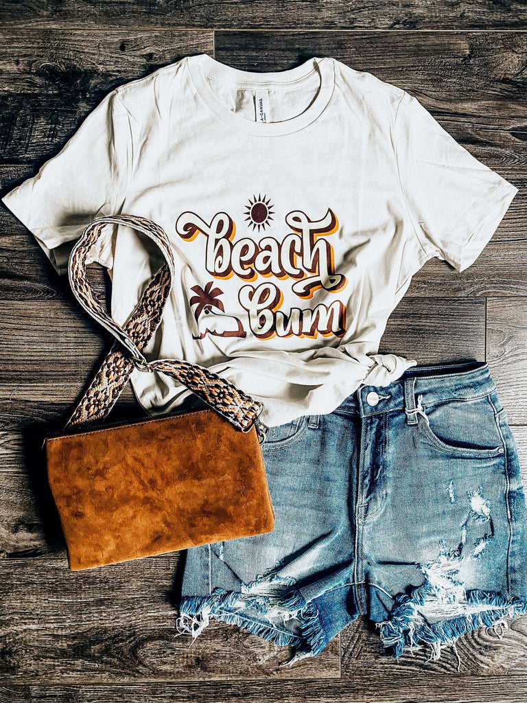 Perfect Tee for that Beach Bum who enjoys the Beach. This Beach Bum Tee is a soft cream colour with a yellow and tan colour front graphic 