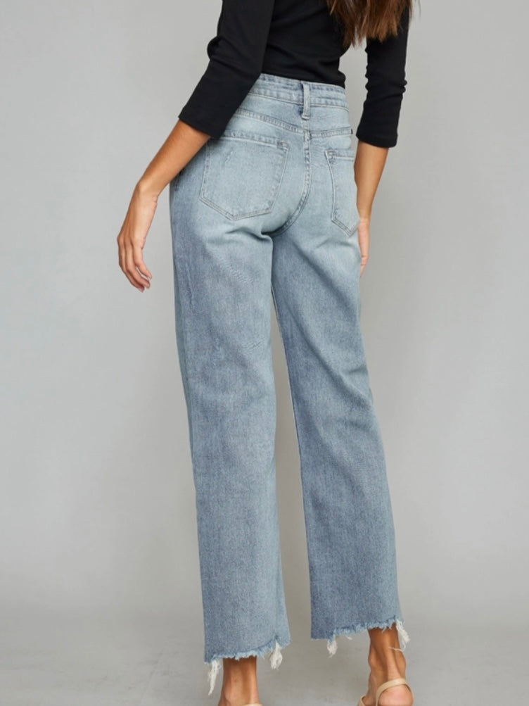 High Rise Slim Wide Leg Jeans lighter fading and whiskering, features a 5-pocket style , single front button closure, and zip fly with frayed hem.