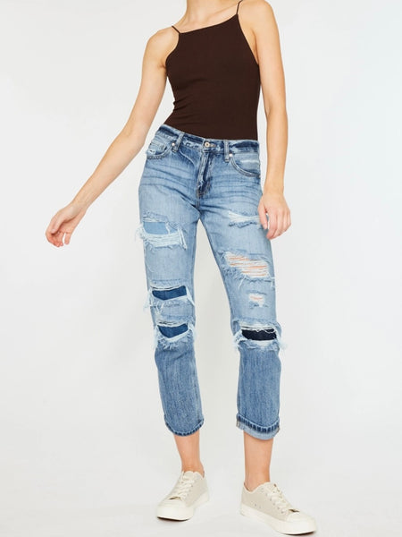 High Waisted ,5 Pocket Single Button Front and zip-fly Jean, with Light Fading and 3d Whisker detail , and moderate destruction with patches on both legs .