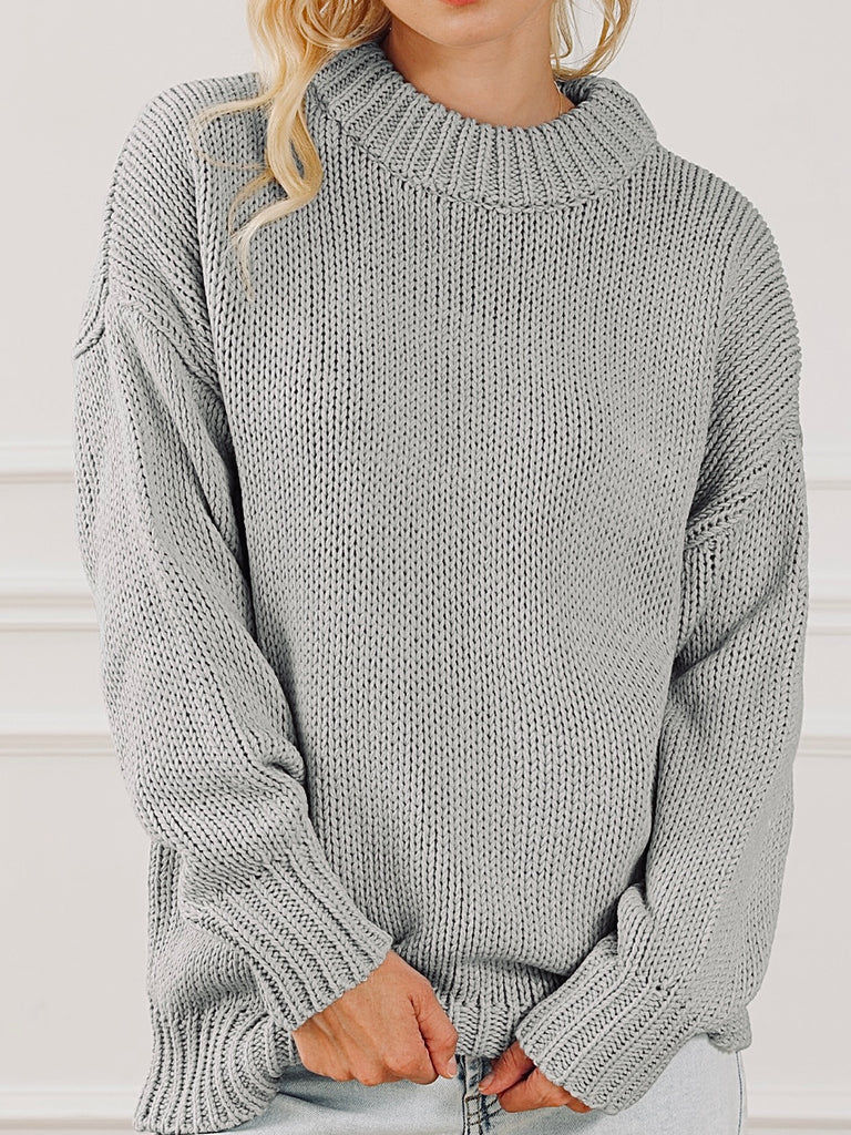 Chunky grey knit sweater with long sleeves.