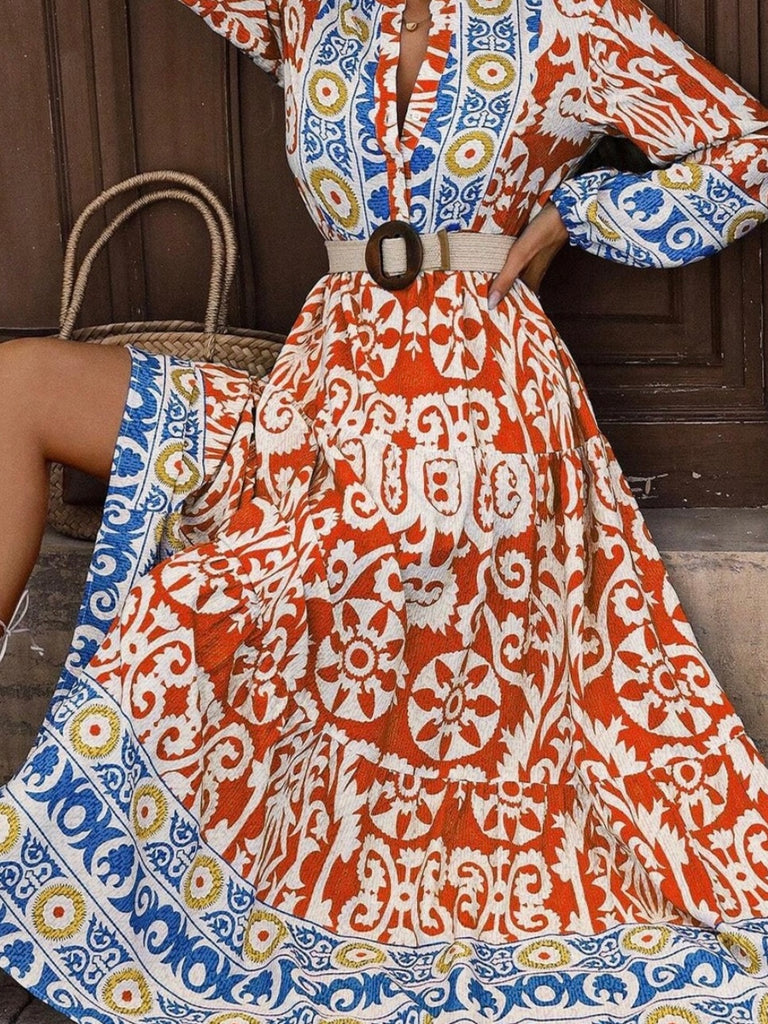  Long Boho Maxi Dress, in a beautiful Spanish print, with a Unique Geometric Pattern, accented by vibrant orangey-red and blue motifs.