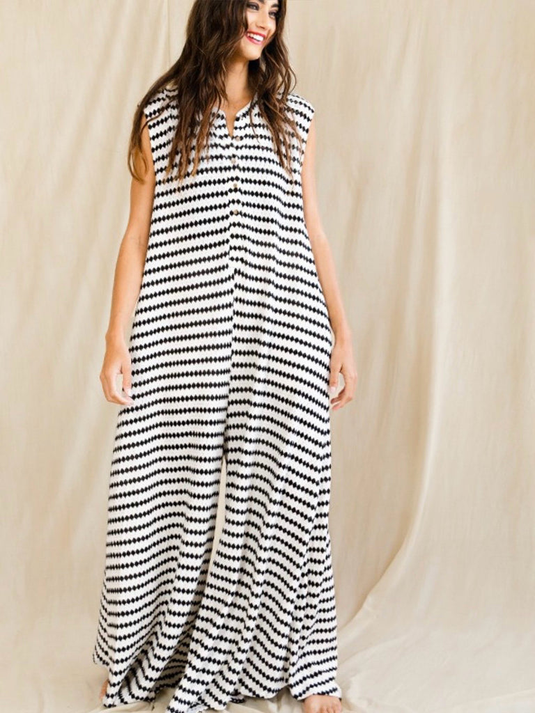 Black and white striped jumpsuit. Sleeveless, round neck, button up and wide legged.