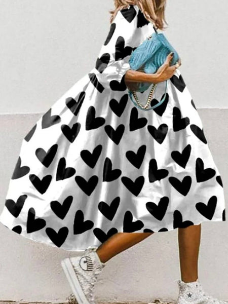  Black and White heart print Dress, with half sleeves, hi low hem, faux wrap and tie neckline with an oversized fit.