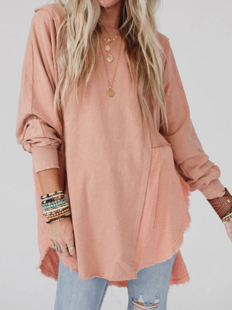 Pink Colour high-low tunic length and split hem pullover, features a round neckline and long sleeves, blend of crinkled gauze and knit, and raw edge design.