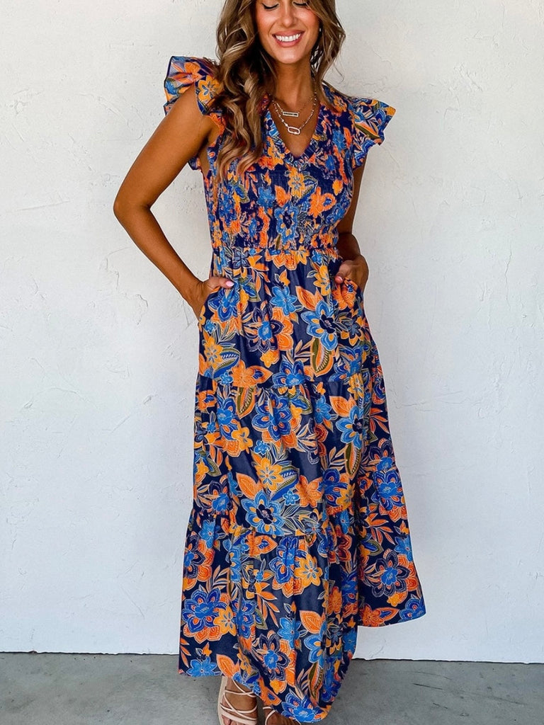 Boho Dress in shades of blue with pops of orange , and features a gorgeous floral print, smocked bodice, and tiered A-line silhouette.