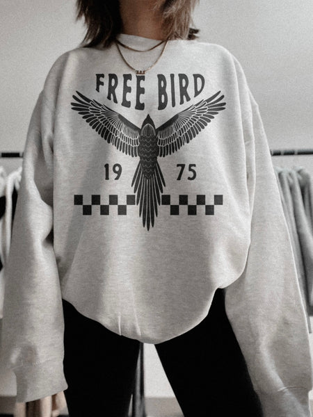 Ash grey oversized graphic sweatshirt, featuring black graphic Free Bird 1975.
