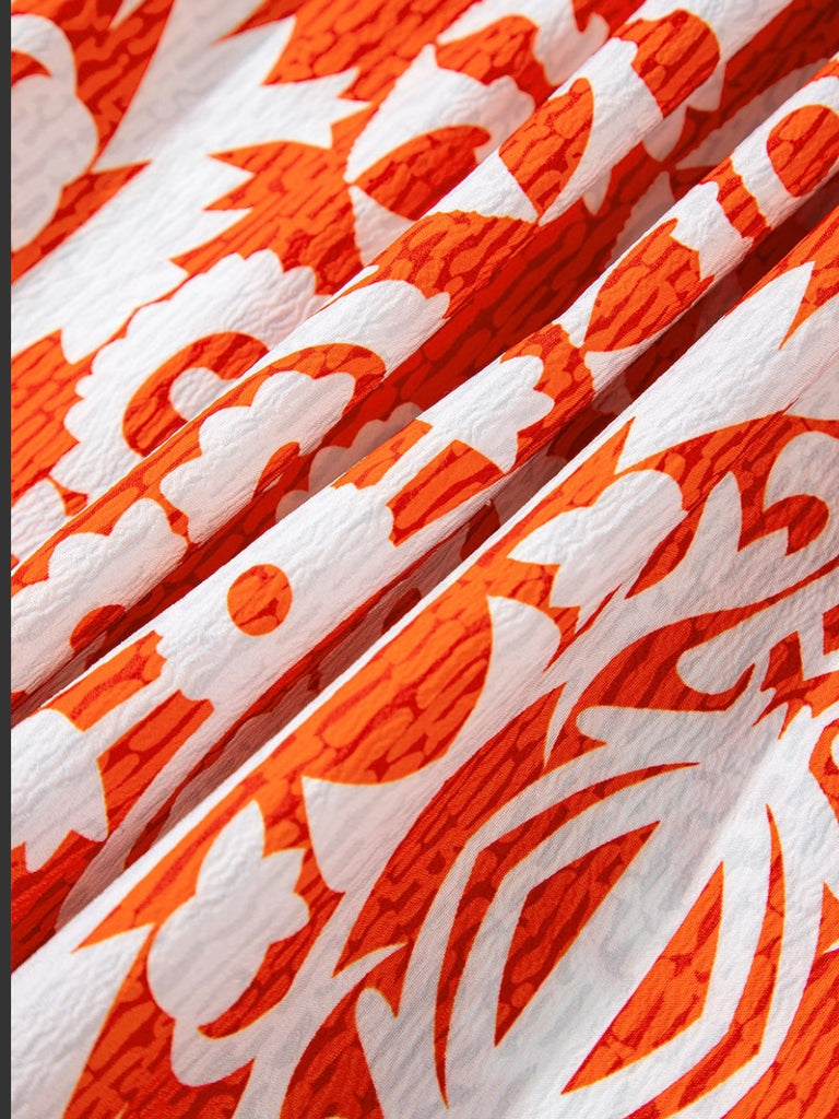  Long Boho Maxi Dress, in a beautiful Spanish print, with a Unique Geometric Pattern, accented by vibrant orangey-red and blue motifs.