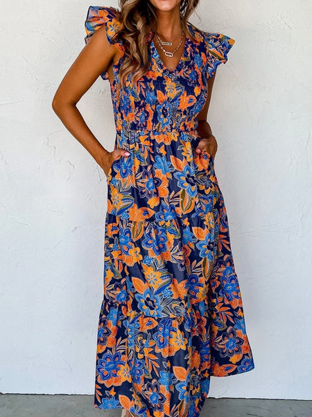 Boho Dress in shades of blue with pops of orange , and features a gorgeous floral print, smocked bodice, and tiered A-line silhouette.