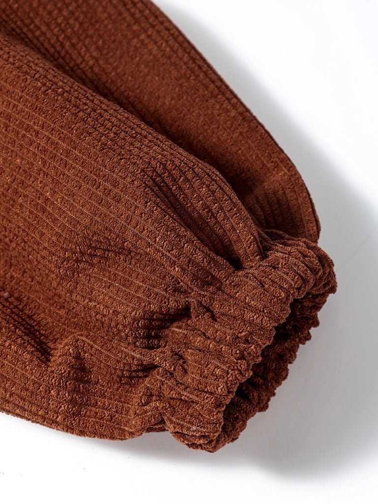 Brown Corduroy Shacket features a trendy oversized fit, with puff sleeves and a pleated back and button front.