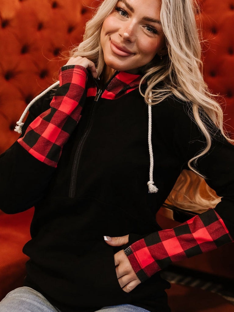 Buffalo plaid half zip sweatshirt with fitted sleeves and pockets.