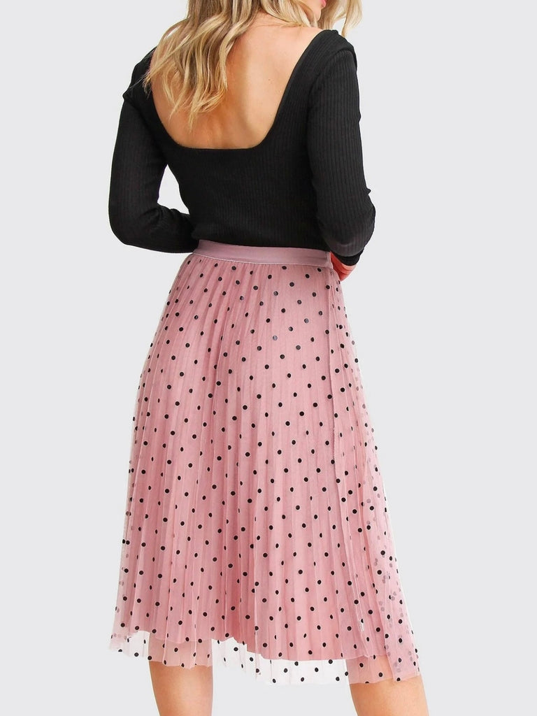 Pink Reversible Skirt, with two stunning looks in one: luxurious velour pleats on one side for an elegant touch, and playful polka-dotted tulle on the reverse side, and features a flared cut and elastic waistband.