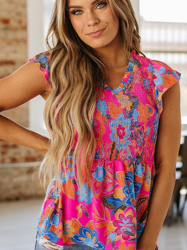 Woman wearing smocked pink floral blouse