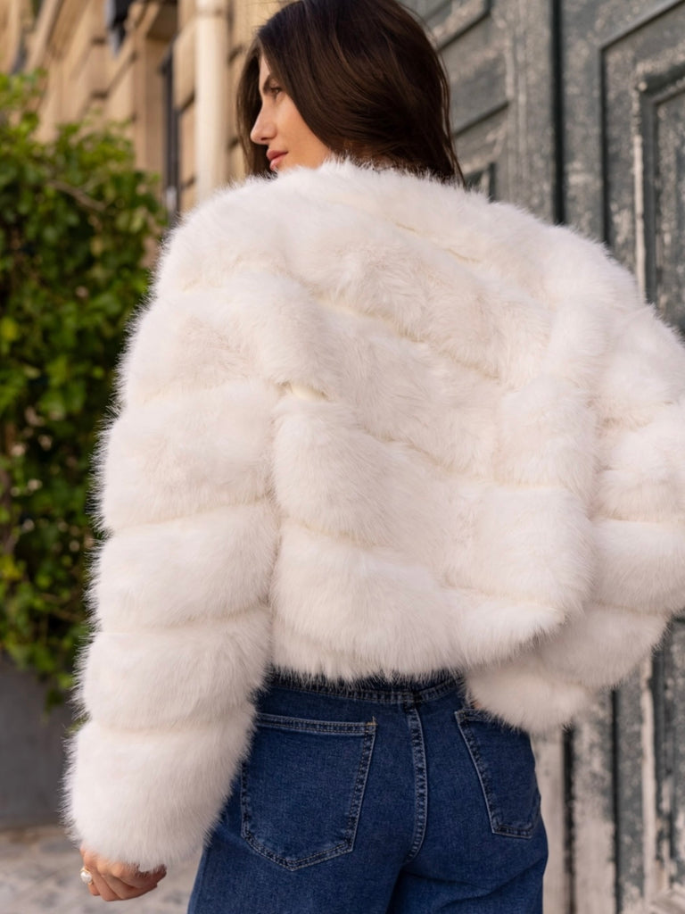 White  , Short faux- fur jacket features soft faux fur with a sleek, diagonal seam , and front button closure for easy fastening. 