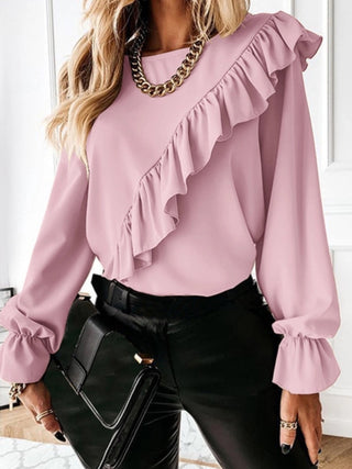 Pink 100% polyester Blouse featuring an asymmetrical ruffle on the front and billowy cuffs.