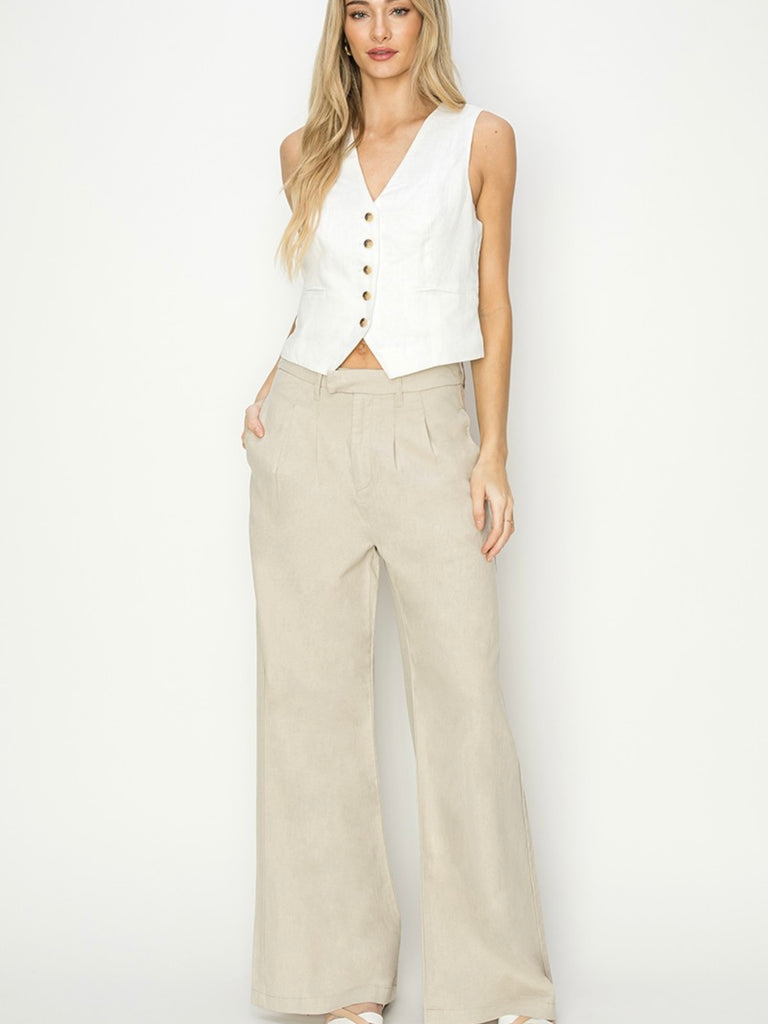 Oversized linen slouch pant with front pleats and pockets. Available in black or tan.
