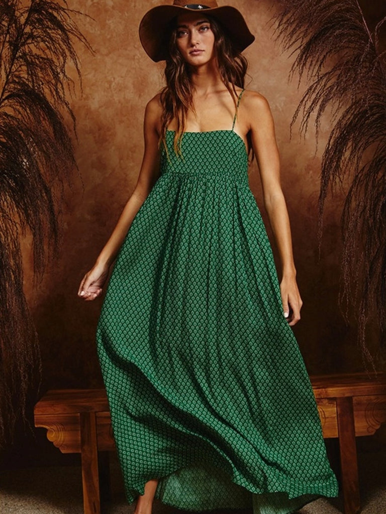 Jasmine Boho Dress. This flowy allover long dress features a playful green print woven fabrication, complete with a double back tie detail and side pockets for added convenience. Pleated for a flattering shape, this dress is perfect for a unique and stylish look!  100% polyester