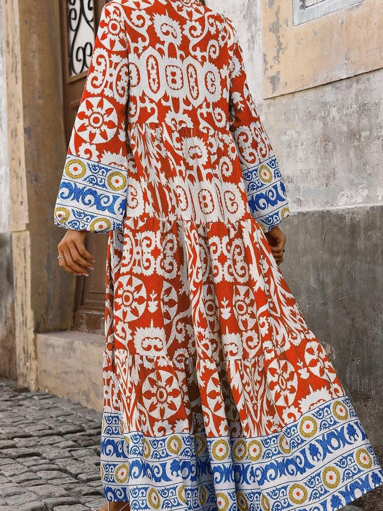  Long Boho Maxi Dress, in a beautiful Spanish print, with a Unique Geometric Pattern, accented by vibrant orangey-red and blue motifs.