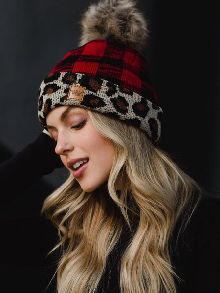 Red buffalo and leopard trim hat with fleece lining and faux pom.