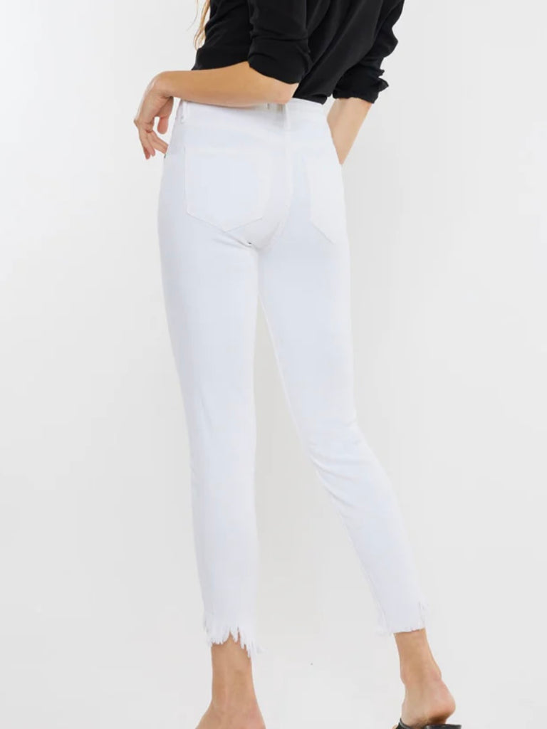 White Kancan Raw Hem ankle-length Skinny Jeans , featuring an asymmetrical raw cut hem and Single button front closure, Zip fly.