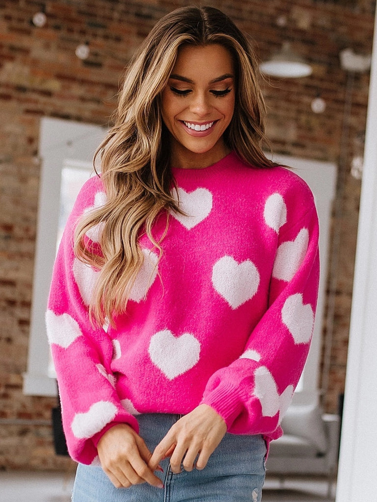 Soft, fuzzy sweater with white hearts on bright pink fabric.  Made from 100% acrylic.
