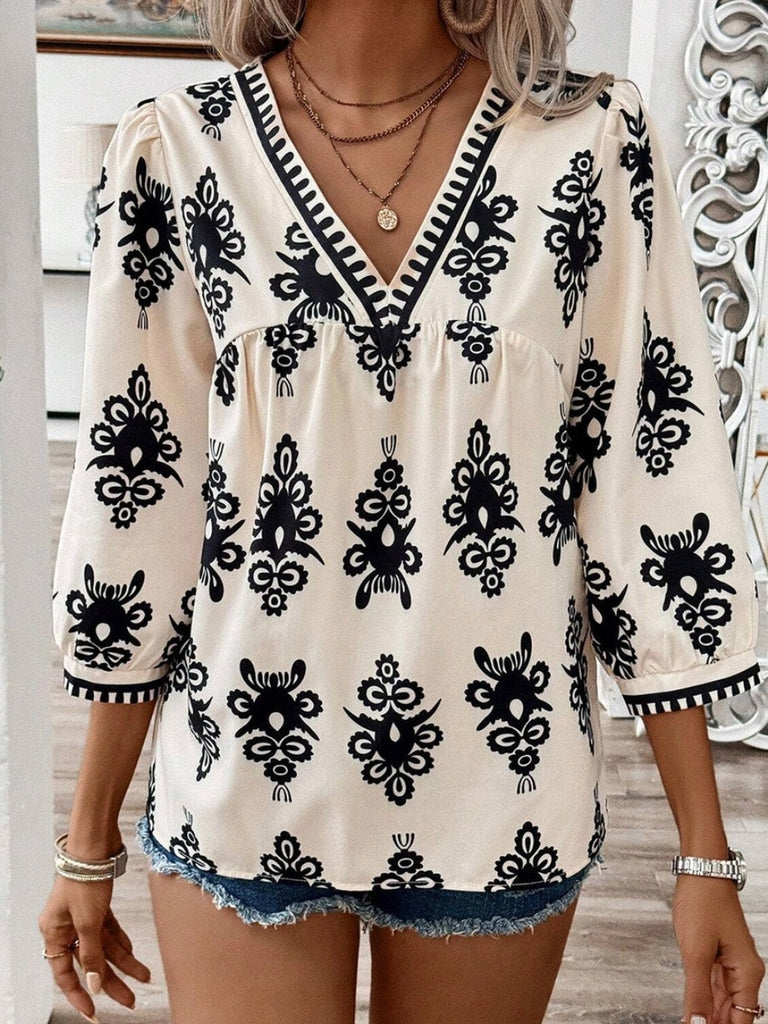  Features V-neck with delicate puff sleeves in a creamy color with a black print ikat design .