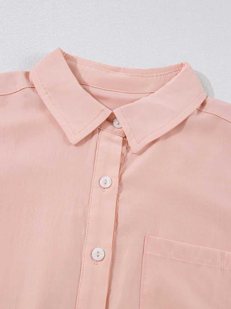 Detail of pointed collar on soft pink shirt dress