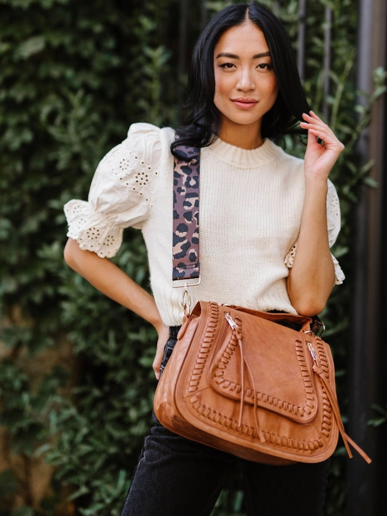 Brown Vegan Purse with adjustable leopard strap , gold hardware and 2 zippered pockets.