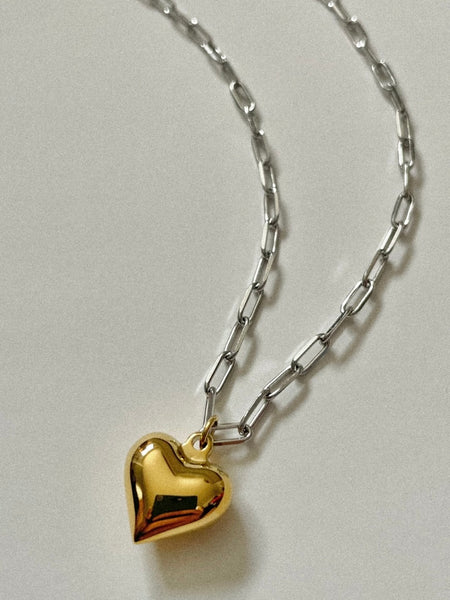 Featuring a chunky gold heart pendant on a silver paper chain 316L stainless steel with 18K PVD gold plating. 