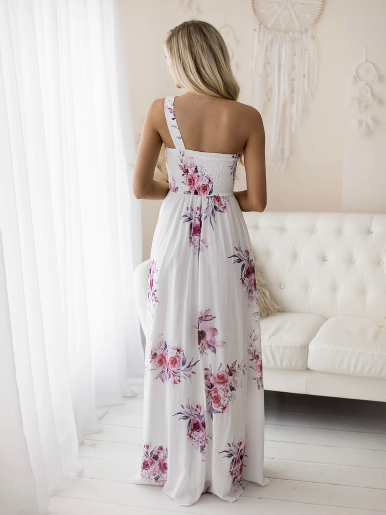 The White Chasing Petals Floral Maxi-Dress , with its playful one -shoulder design and smocked back for a comfortable flattering fit.