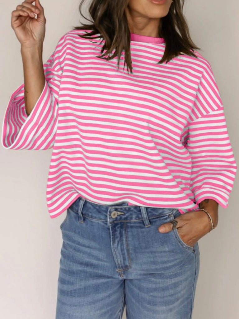 Front view of a pink striped long sleeve blouse with a relaxed fit and drop shoulders.