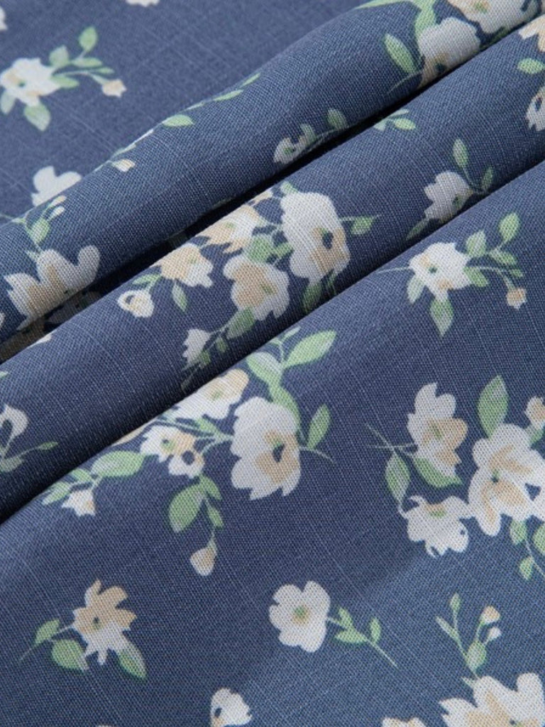 Folded fabric showing floral print on blue background in soft texture