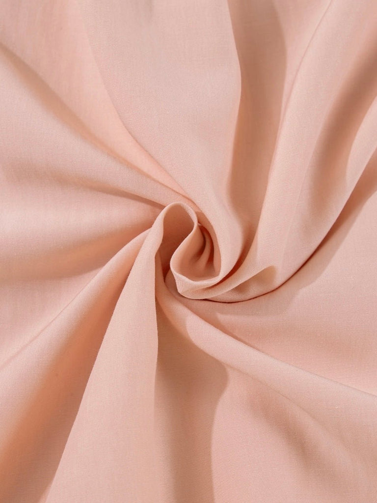 Close-up of soft pink fabric swirled to show texture and drape