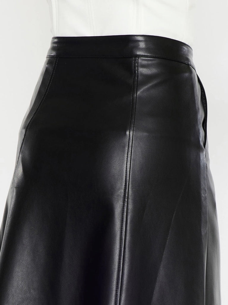 Black Faux -Leather Skirt features a high waistline, Exposed Snap Button Closure, the length of the skirt falls to the floor, and has handy pockets.