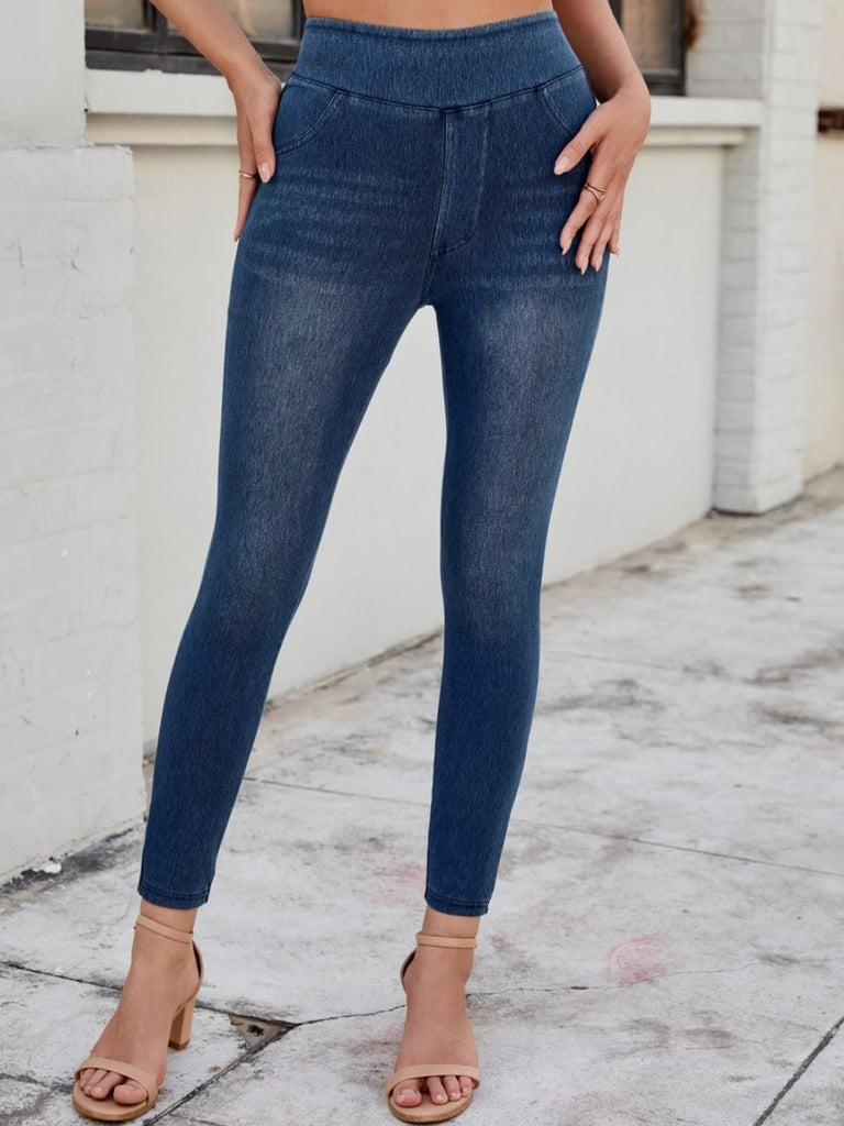Full-body image of woman in high-rise jeggings with a clean front and tapered leg.