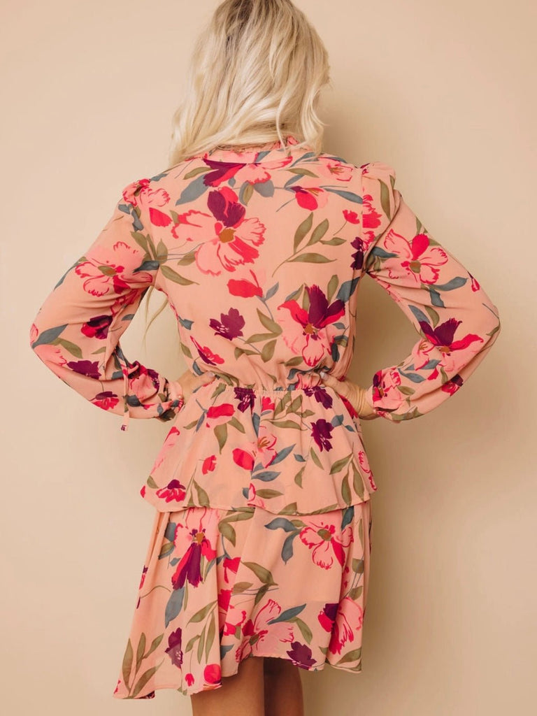 Midi Dress with tiered skirt , and v -neckline and mock button details features a frilled floral ruffle design, with a peachy pink and burgundy floral print.