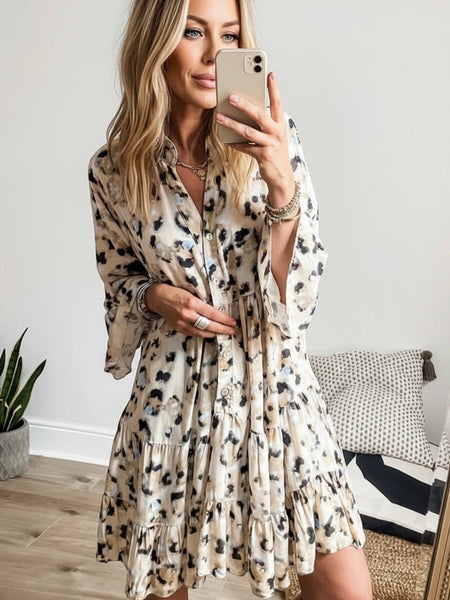 Woman taking a selfie wearing a leopard print dress with an icy blue accent, Oak&Pearl Clothing Co.