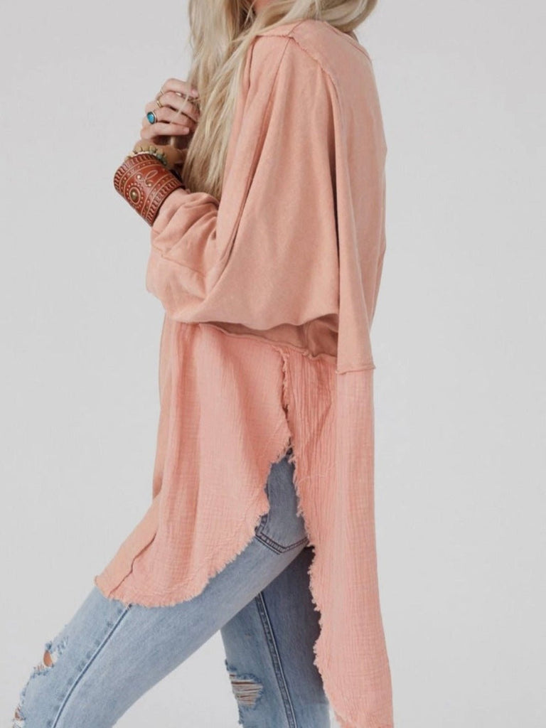 Pink Colour high-low tunic length and split hem pullover, features a round neckline and long sleeves, blend of crinkled gauze and knit, and raw edge design.