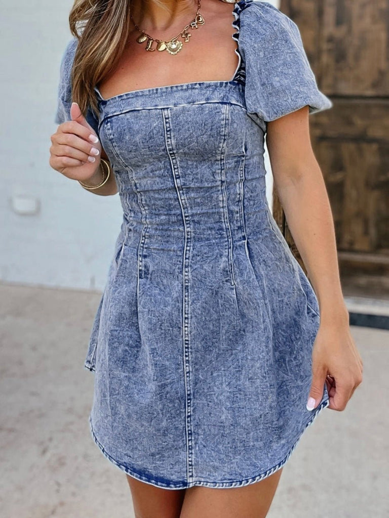 Washed denim bustier dress with puff sleeves styled with cowboy boots