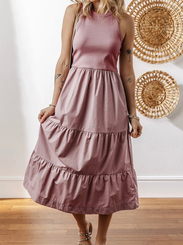 Woman wearing dusty pink tiered midi dress