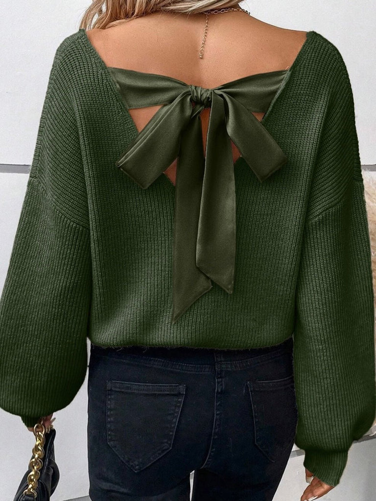 A beige colored sweater with lantern sleeves, V-neckline, and a unique knot detail at the back tied with a ribbon.
