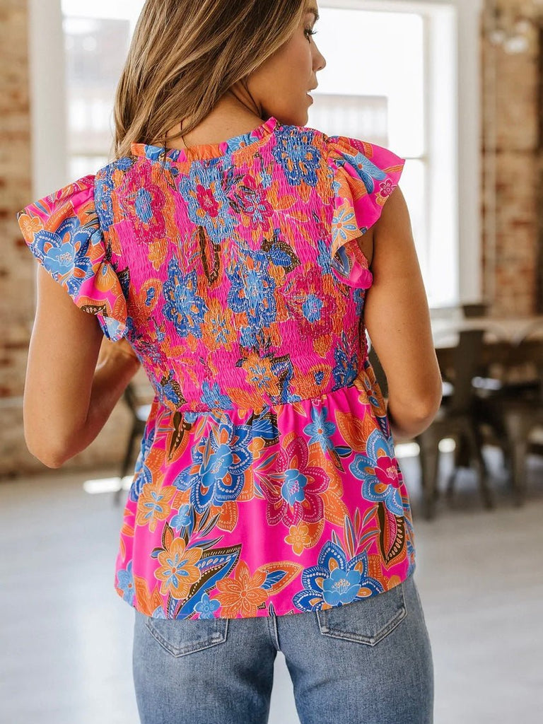 Back view of pink floral smocked peplum top