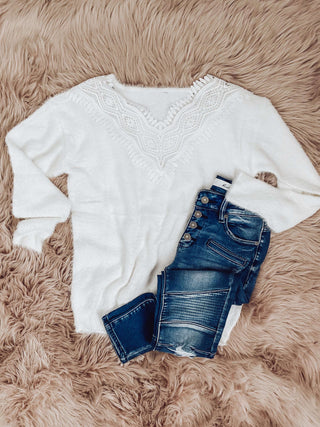 Crisp White Sweater, with a loose fit, and gorgeous lace trim around the neckline.