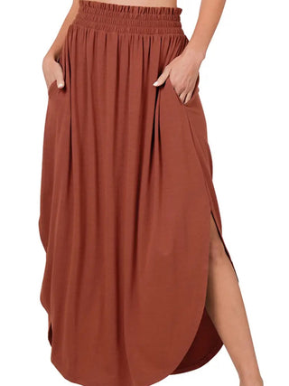 Dark Rust Maxi- Skirt smocking waist band side slit and side pockets with rounded hem-line.