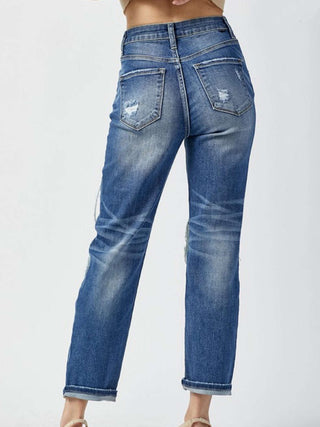 Stretchy High Rise Straight Leg Jeans with a cropped length and Patches on the front  and some distressing on the back pockets.