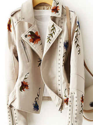 Chevelle  Moto -Style Jacket hanging in white with its beautiful floral embroidery and silver studs.