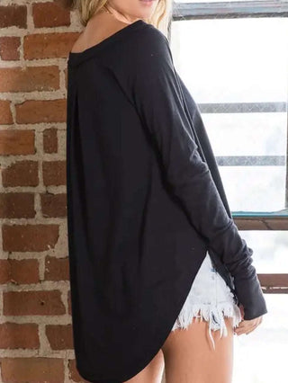 Black Tunic length Crewneck Top has round raw hem with thumb holes and is made from polyester, and boasts a longer fit.